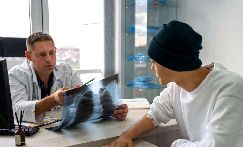 The doctor explains the chest X-ray to the patient